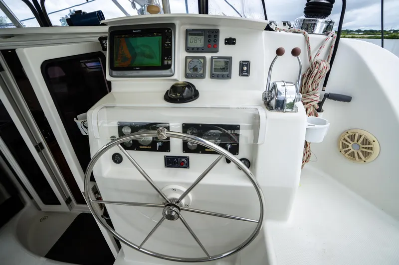 Dreaming On Yacht Photos Pics Helm of 2003 Leopard 47 catamaran with navigation instruments and steering wheel.