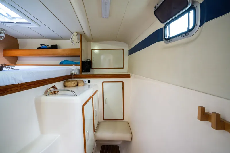 Dreaming On Yacht Photos Pics Compact cabin interior of a 2003 Leopard 47 catamaran with bed, storage, and window.