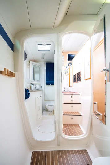 Dreaming On Yacht Photos Pics Interior of a 2003 Leopard 47 yacht featuring a compact bathroom and wooden steps.