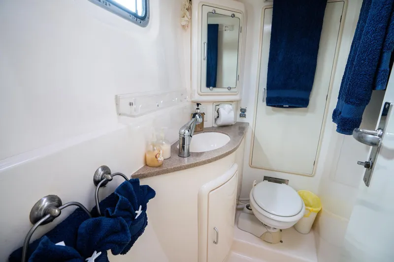 Dreaming On Yacht Photos Pics Compact bathroom in a 2003 Leopard 47 yacht, featuring sink, mirror, and toilet.