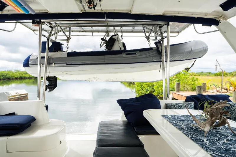 Dreaming On Yacht Photos Pics Luxurious 2003 Leopard 47 yacht interior with a suspended dinghy and scenic waterway view.