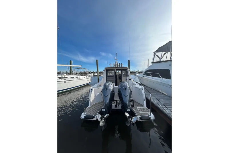  Yacht Photos Pics 2024 Cutwater C-288 Coupe docked, showcasing dual outboard motors and sleek design.