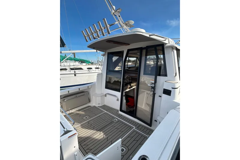  Yacht Photos Pics 2024 Cutwater C-288 Coupe boat with sleek deck and modern cabin entrance.