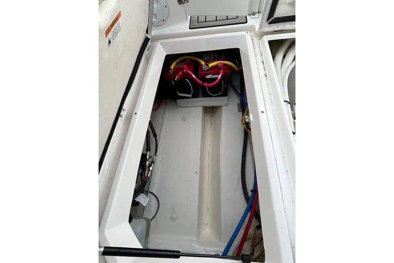 Yacht Photos Pics 2024 Cutwater C-288 Coupe battery compartment with wiring and storage space.