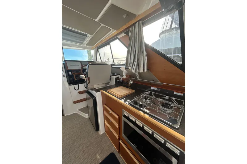  Yacht Photos Pics 2024 Cutwater C-288 Coupe interior with kitchen and helm station.