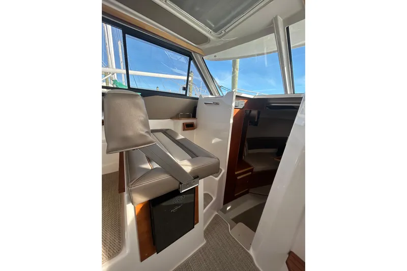  Yacht Photos Pics 2024 Cutwater C-288 Coupe interior with helm seat and cabin view.