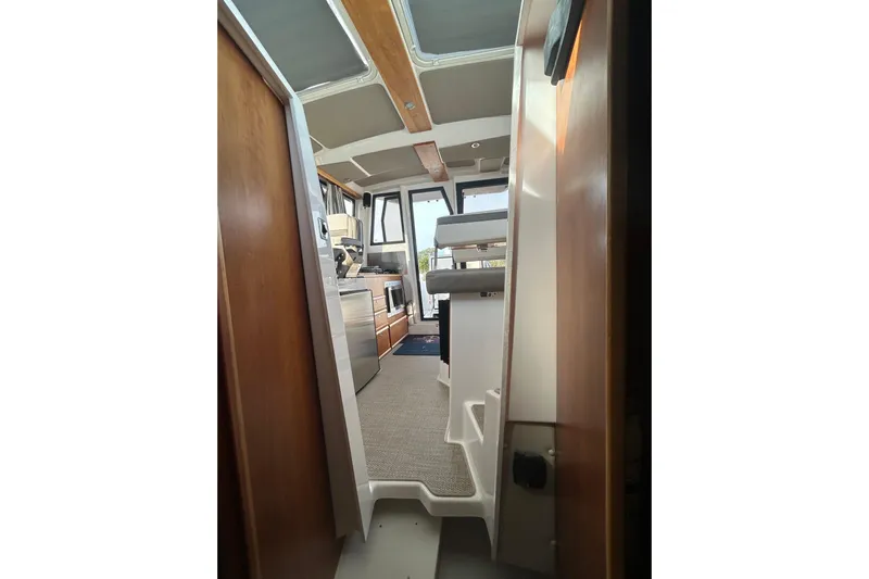  Yacht Photos Pics Interior view of 2024 Cutwater C-288 Coupe, showcasing stairs and cabin layout.