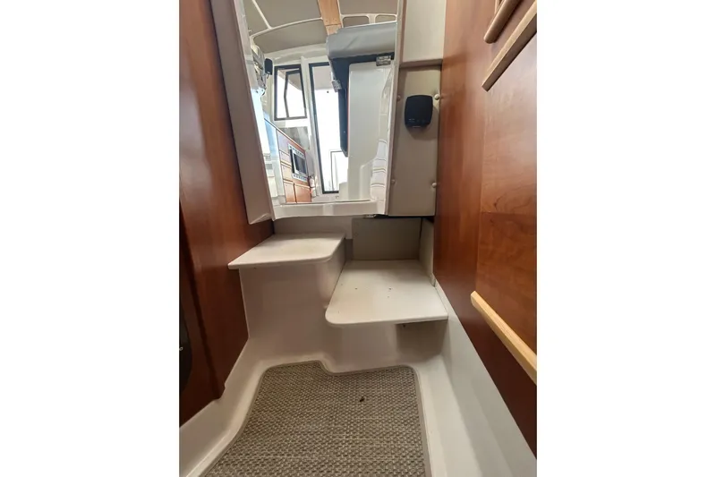  Yacht Photos Pics 2024 Cutwater C-288 Coupe interior with wooden accents and compact steps.