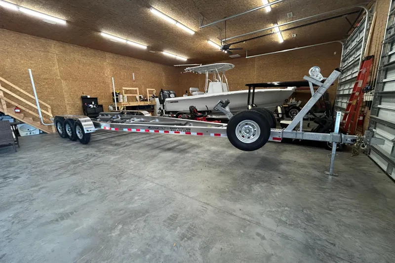  Yacht Photos Pics 2024 Cutwater C-288 Coupe in a garage with a boat trailer.