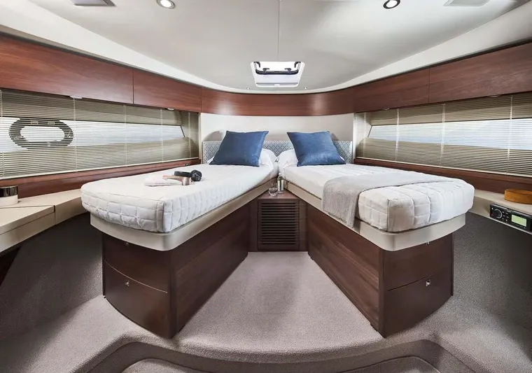  Yacht Photos Pics Luxurious 2025 Princess 50 Flybridge yacht cabin with twin beds and elegant wood finish.