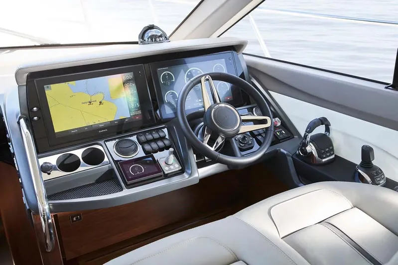  Yacht Photos Pics 2025 Princess 50 Flybridge yacht helm with advanced navigation system and luxurious seating.