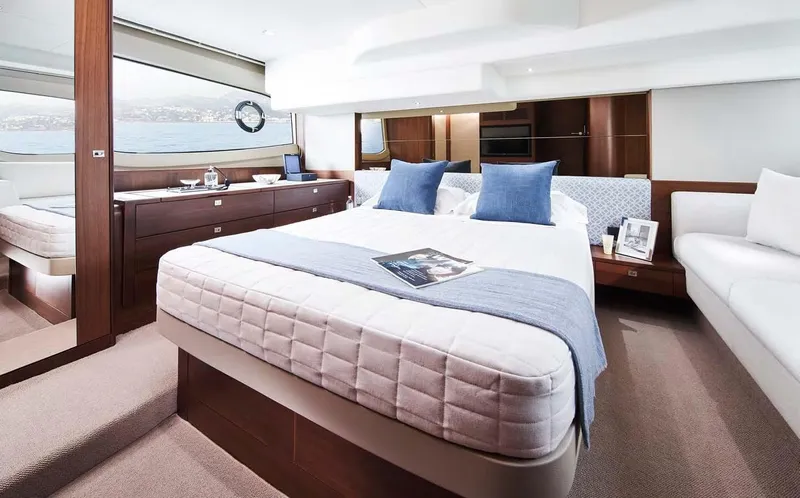  Yacht Photos Pics Luxurious 2025 Princess 50 Flybridge yacht bedroom with elegant decor and scenic window view.