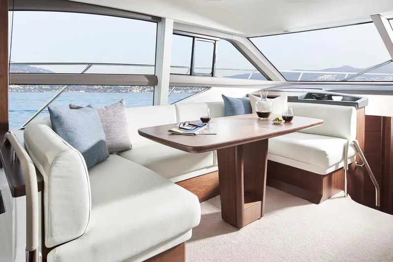  Yacht Photos Pics Luxurious interior of 2025 Princess 50 Flybridge yacht with elegant seating and table.