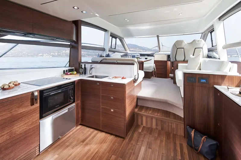  Yacht Photos Pics Luxurious 2025 Princess 50 Flybridge yacht interior with modern kitchen and seating area.