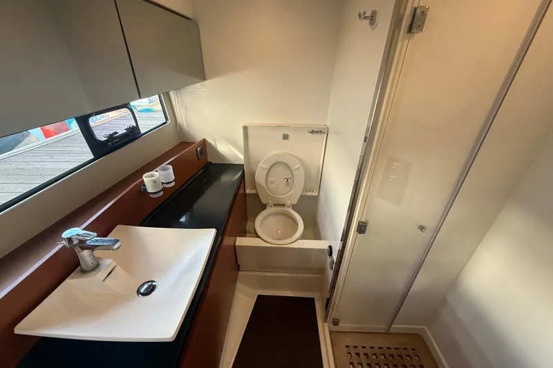  Yacht Photos Pics Modern bathroom in 2016 Prestige 450S yacht with sink, toilet, and shower.