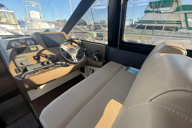  Yacht Photos Pics Interior cockpit of 2016 Prestige 450S yacht with steering wheel and navigation controls.