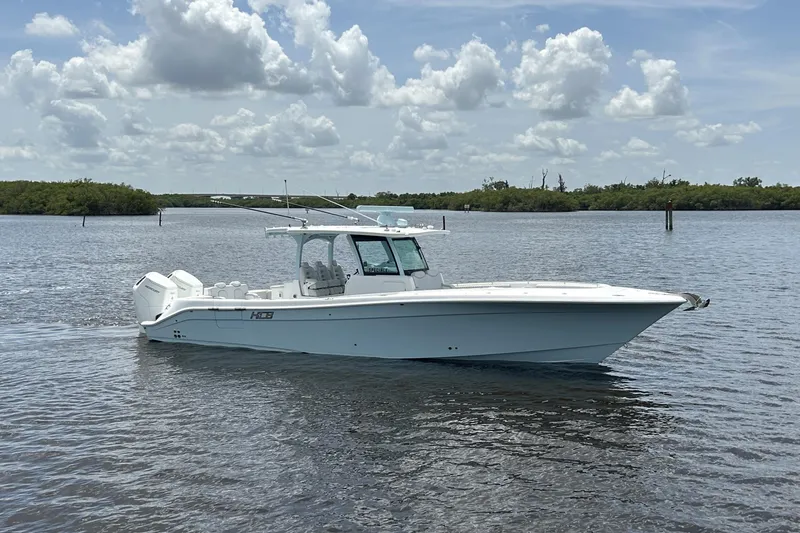  Yacht Photos Pics 2023 HCB 39 Speciale boat on calm water under a partly cloudy sky.