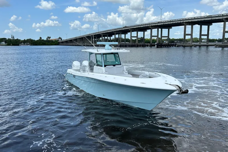  Yacht Photos Pics 2023 HCB 39 Speciale boat cruising near a bridge on a sunny day.