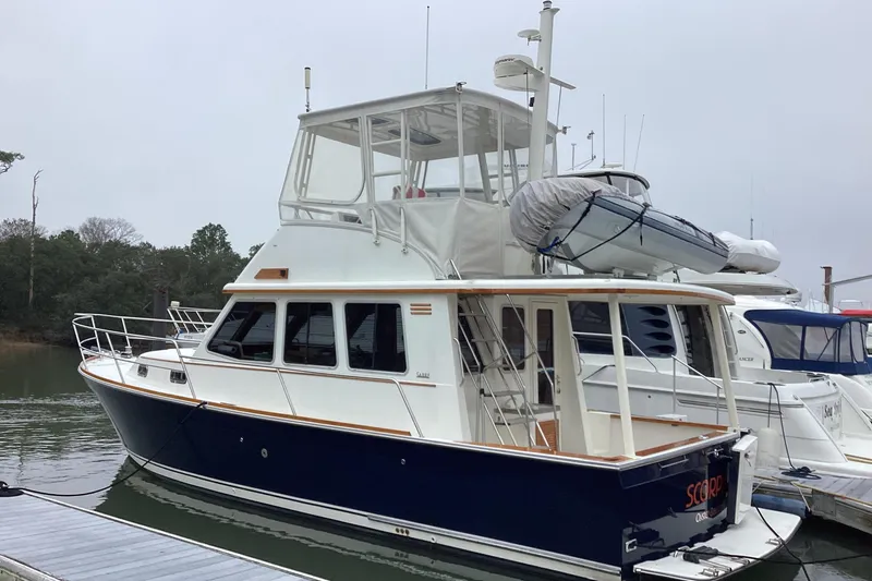  Yacht Photos Pics 2005 Sabre Flybridge yacht docked, featuring a sleek design and spacious upper deck.