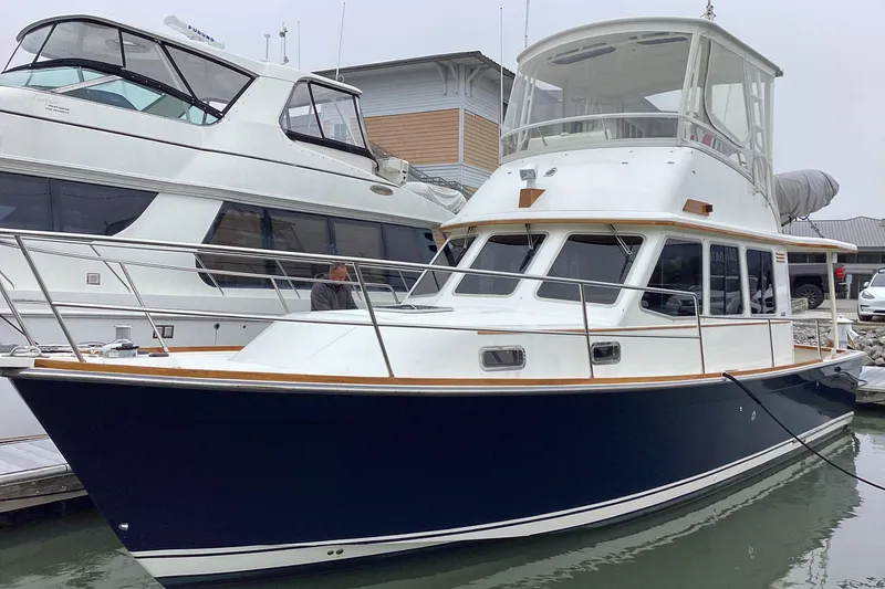  Yacht Photos Pics 2005 Sabre Flybridge yacht docked at marina, featuring sleek design and spacious upper deck.