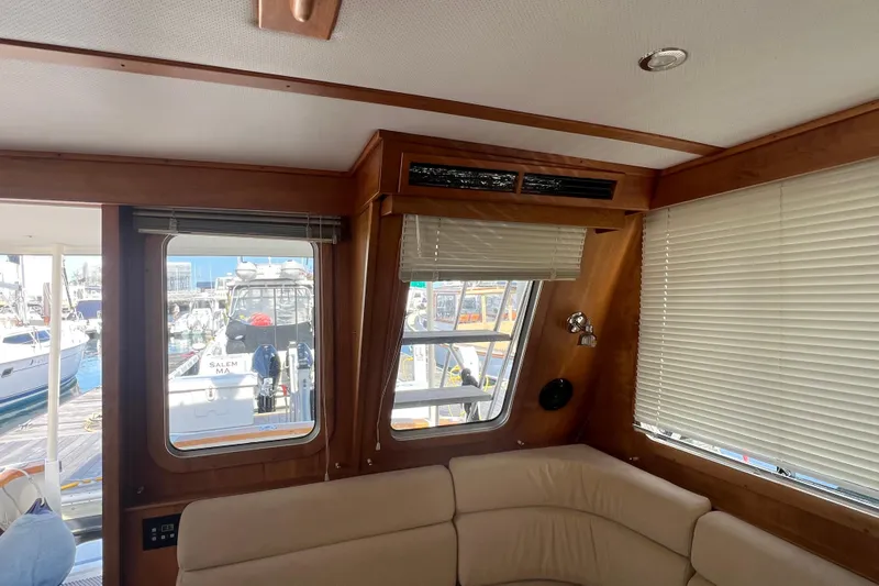  Yacht Photos Pics Interior of 2005 Sabre Flybridge yacht with beige seating and marina view.