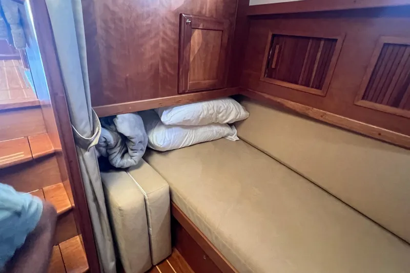  Yacht Photos Pics 2005 Sabre Flybridge interior with cozy wooden cabin and cushioned seating area.