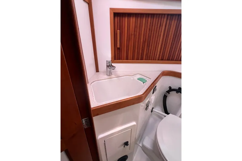  Yacht Photos Pics 2005 Sabre Flybridge bathroom with sink, wooden accents, and modern fixtures.