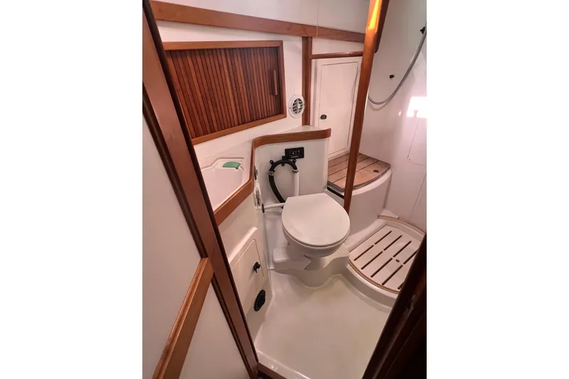  Yacht Photos Pics 2005 Sabre Flybridge yacht bathroom with wooden accents and modern fixtures.