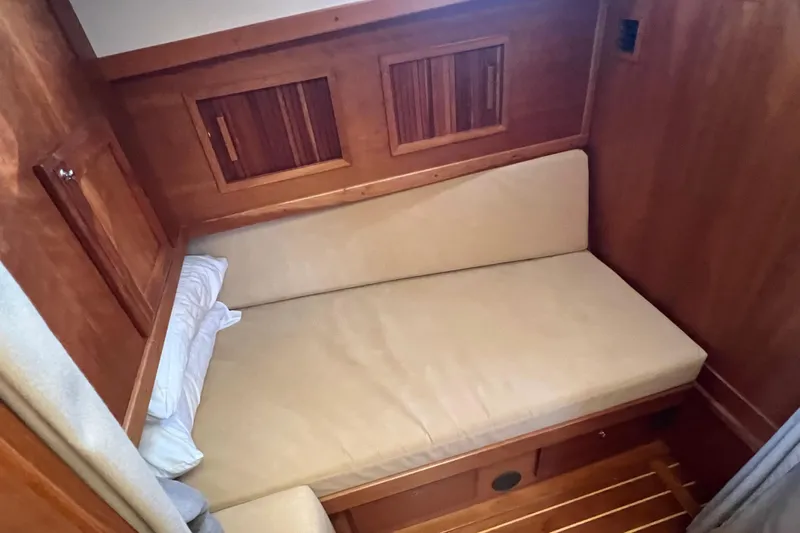  Yacht Photos Pics 2005 Sabre Flybridge cabin interior with wooden finish and cozy bed.