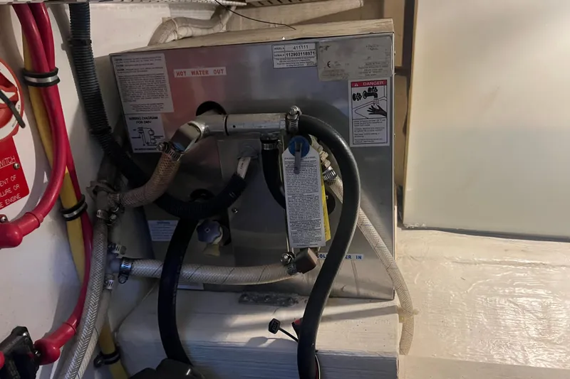  Yacht Photos Pics Engine room of 2005 Sabre Flybridge with visible piping and warning labels.