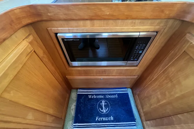  Yacht Photos Pics 2005 Sabre Flybridge interior with built-in microwave and welcome mat.