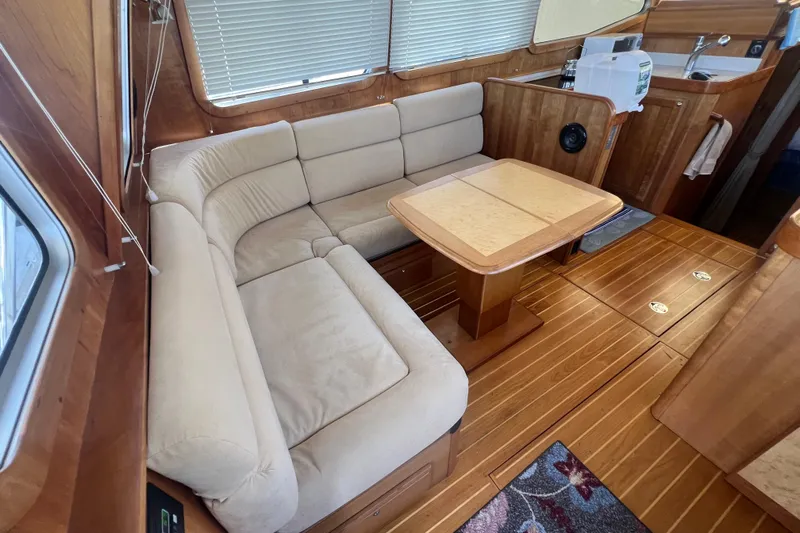  Yacht Photos Pics Luxurious 2005 Sabre Flybridge interior with plush seating and elegant wooden finishes.