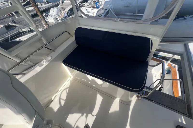 Yacht Photos Pics 2005 Sabre Flybridge interior with blue cushioned seating and marina view.