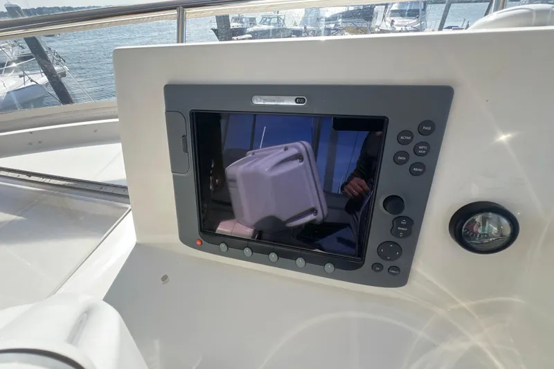  Yacht Photos Pics 2005 Sabre Flybridge control panel with navigation display and buttons, overlooking marina.