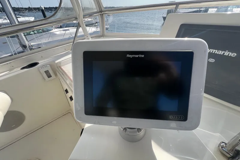  Yacht Photos Pics 2005 Sabre Flybridge with Raymarine navigation system, docked by the water.