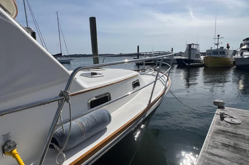  Yacht Photos Pics 2005 Sabre Flybridge yacht docked at marina, sunny day, calm waters.