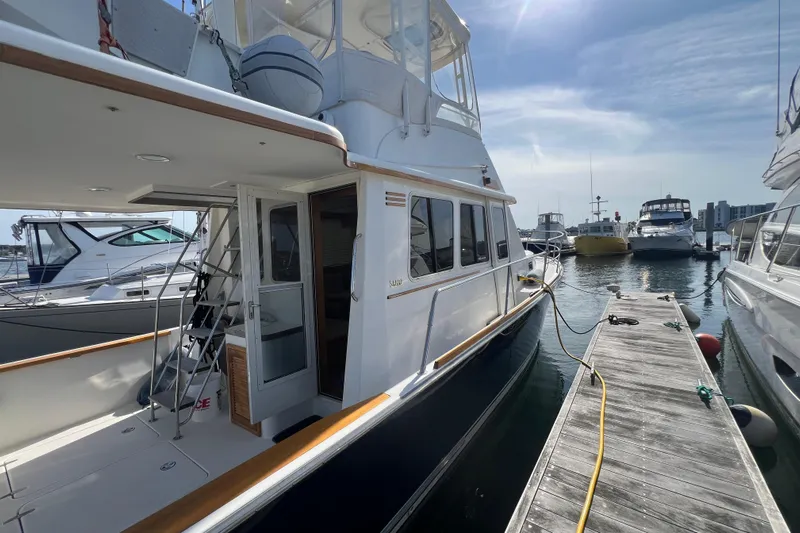  Yacht Photos Pics 2005 Sabre Flybridge yacht docked at marina under clear sky.