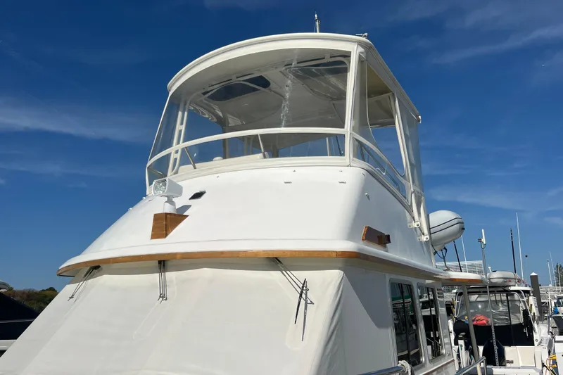  Yacht Photos Pics 2005 Sabre Flybridge yacht with white exterior, docked under a clear blue sky.