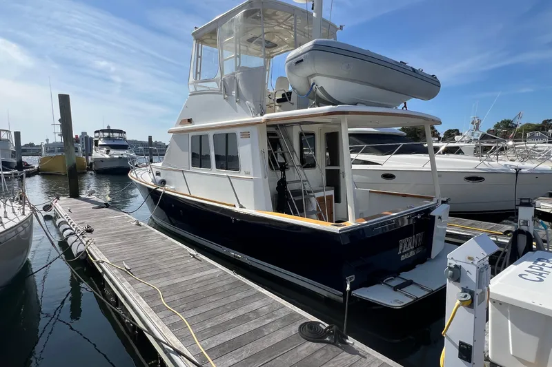  Yacht Photos Pics 2005 Sabre Flybridge yacht docked at marina under clear blue sky.