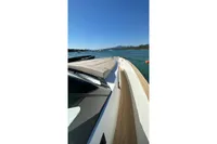 2008 Fjord 40' Open yacht on serene blue waters with scenic mountain backdrop.