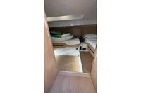 Interior cabin of 2008 Fjord 40' Open yacht with wooden flooring and twin beds.