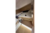Interior cabin of 2008 Fjord 40' Open yacht with cozy bed setup.