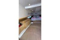 Interior cabin of 2008 Fjord 40' Open yacht with bed and wooden furnishings.