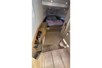 Interior of 2008 Fjord 40' Open yacht with cozy bedroom and wooden furnishings.