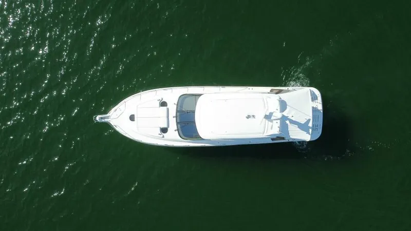 Dreamscape Yacht Photos Pics Aerial view of 2008 Tiara Yachts 5800 Sovran cruising on green water.