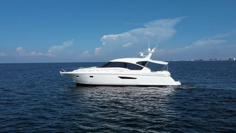Dreamscape Yacht Photos Pics 2008 Tiara Yachts 5800 Sovran cruising on open water under clear skies.