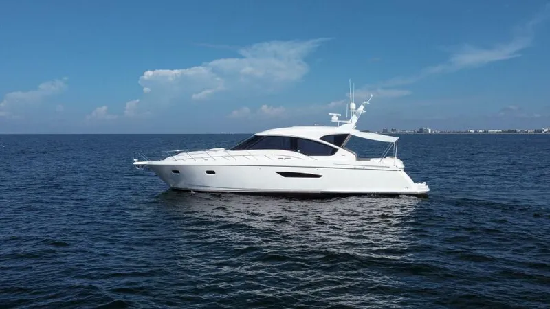 Dreamscape Yacht Photos Pics 2008 Tiara Yachts 5800 Sovran cruising on open water under clear skies.