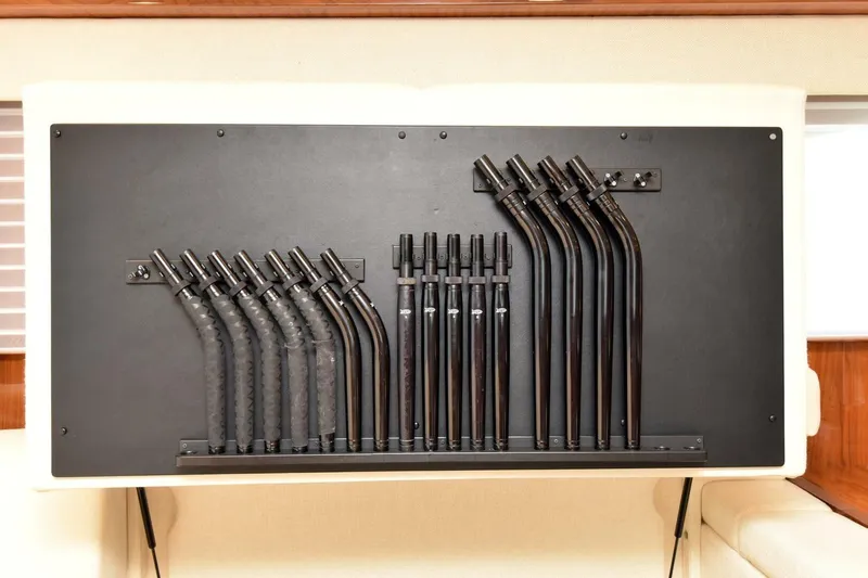  Yacht Photos Pics Fishing rod storage on 2019 Viking 80 Skybridge yacht, featuring organized black holders.