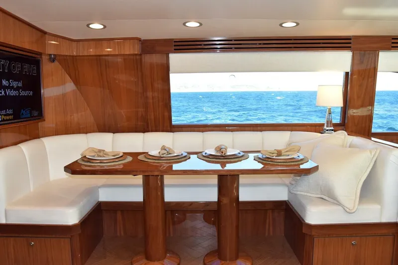 Yacht Photos Pics Luxurious dining area on 2019 Viking 80 Skybridge yacht with ocean view.
