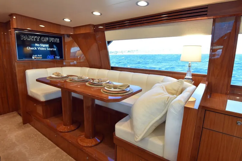  Yacht Photos Pics Luxurious interior of 2019 Viking 80 Skybridge yacht with elegant dining area and ocean view.